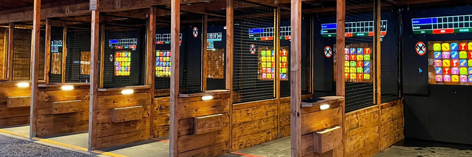 rows of axe throwing stalls in winchester, ca at wild west social